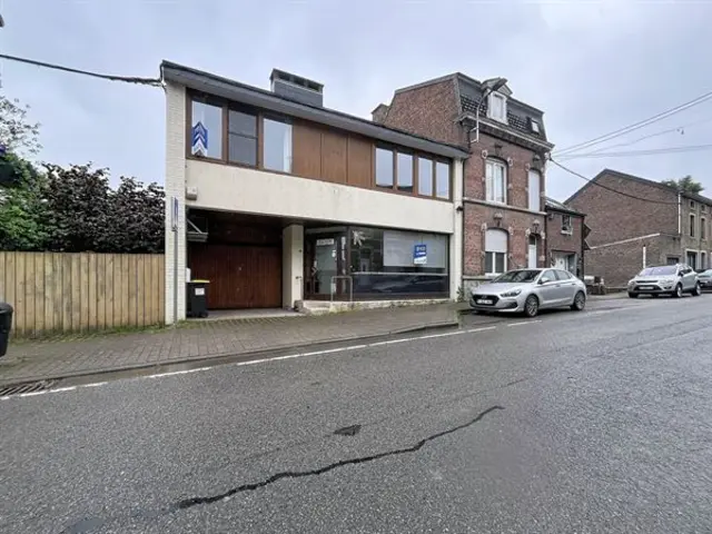 Gemengd gebouw met handelsruimte, woning en tuin.